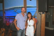 BARNEY BENTALL, LORI MCPHEE AT WEST BEACH IN FRONT OF A WALL MURAL CREATED BY LORI MCPHEE